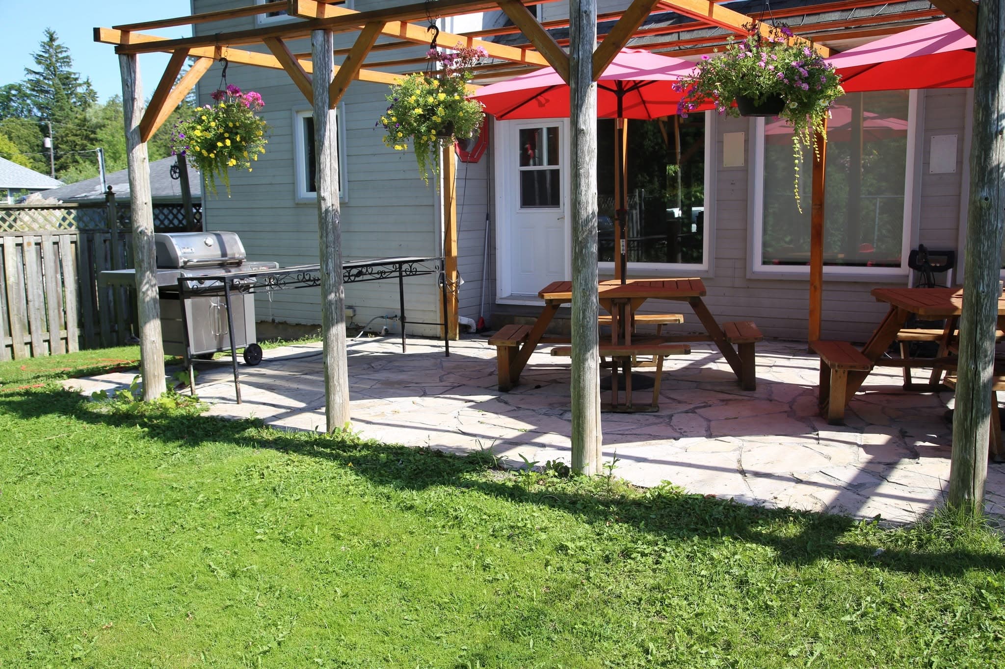 The back of the house with its pergola, picnic tables and sunroom windows